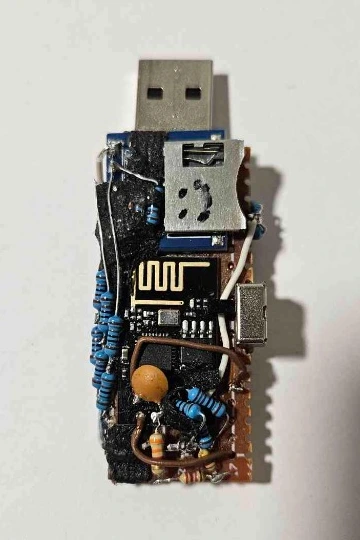 Top side of the RISE prototype showing the USB-A plug, microSD slot with a drawn smiley face, ESP-01 Wi-Fi module, side slide switch, and stacked blue through-hole resistors.